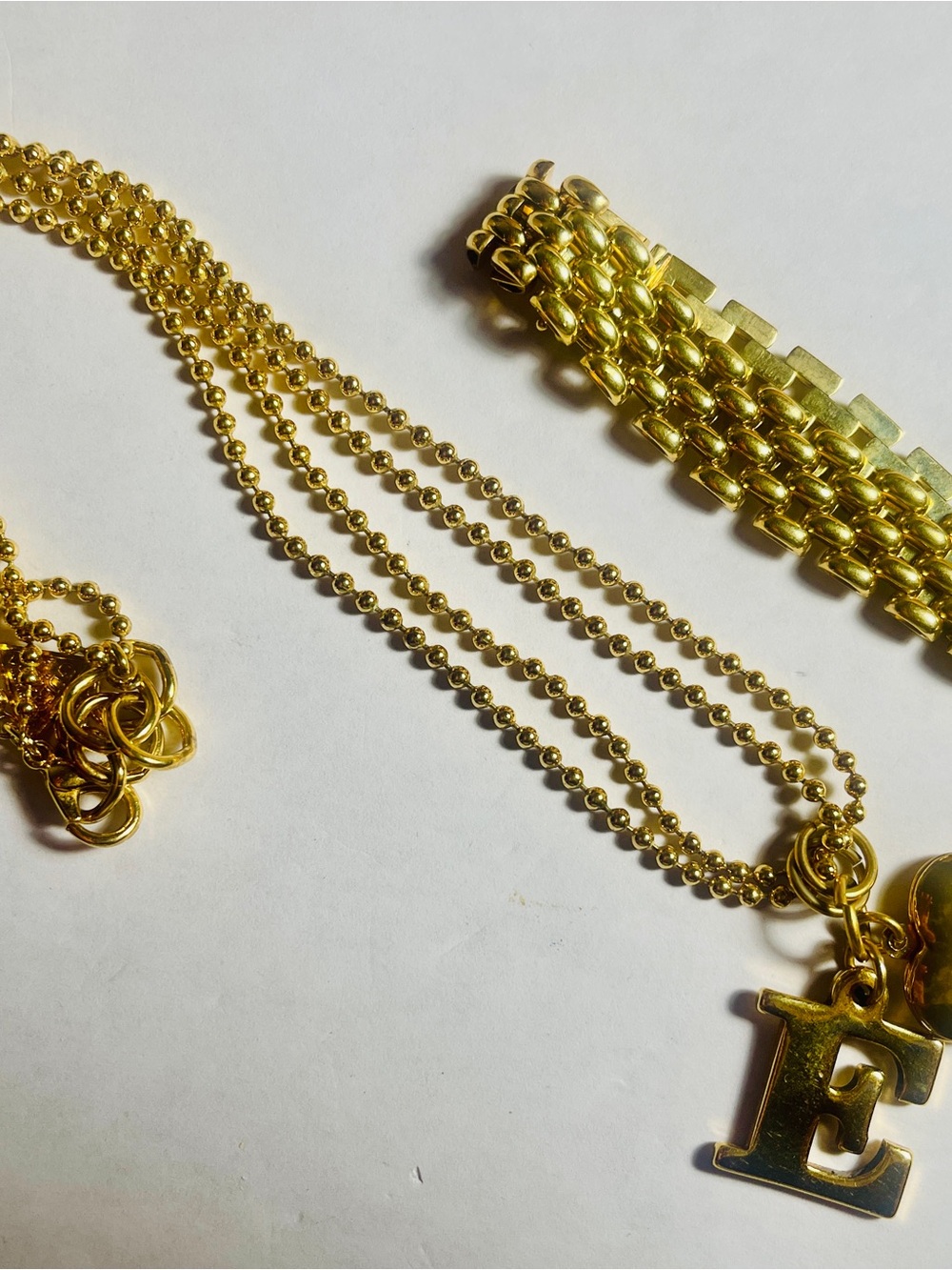 Guess Gold-Tone 'E' Initial Pendant Necklace, bracelet. For the “E” in your life